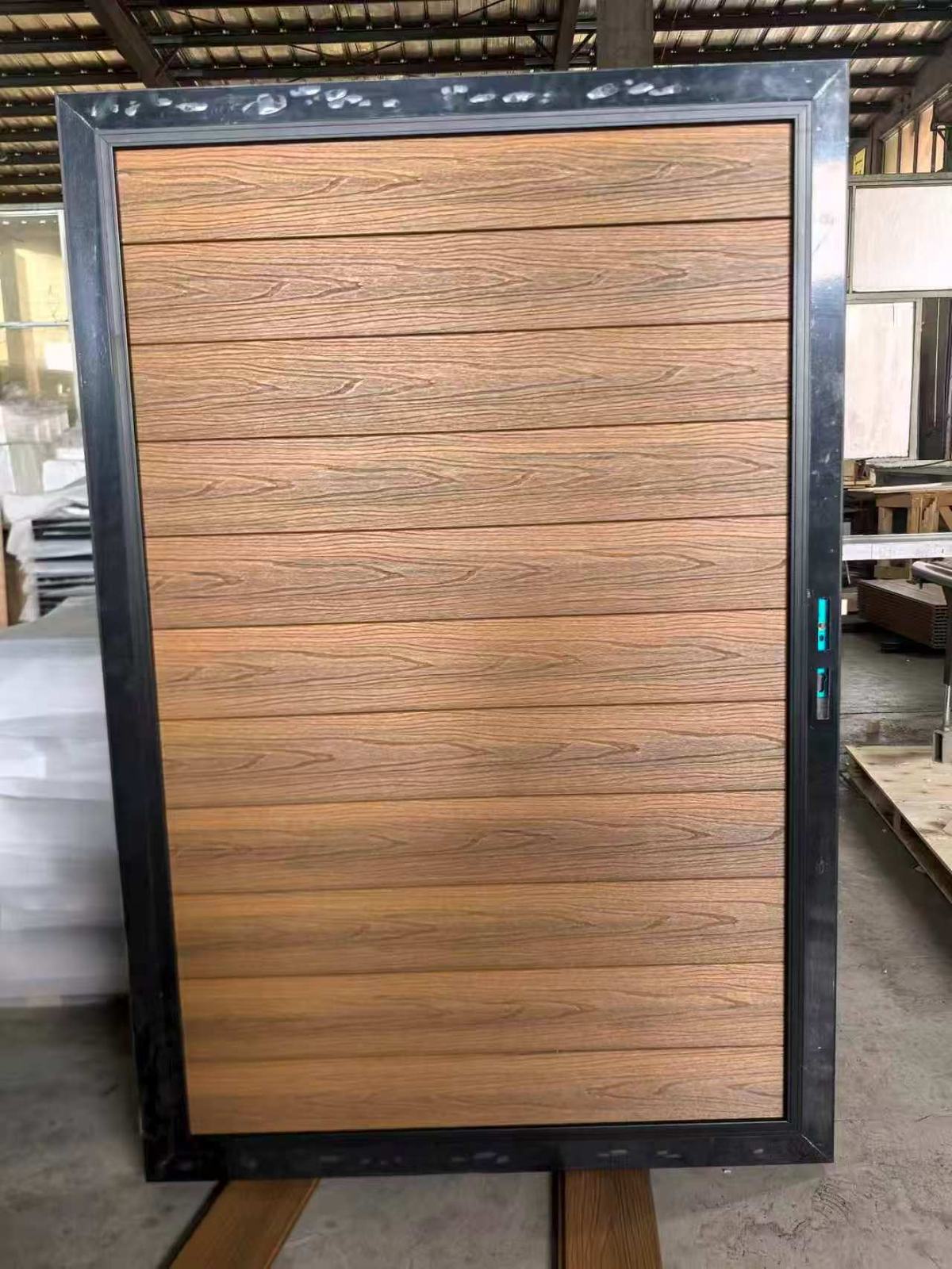 Teak WPC gate leaf with black aluminum frame and pre-fitted lock hardware