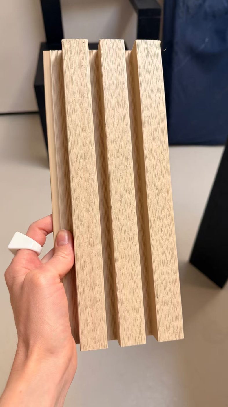 Close view of a Maple WPC cladding board showing the fluted profile and grain texture