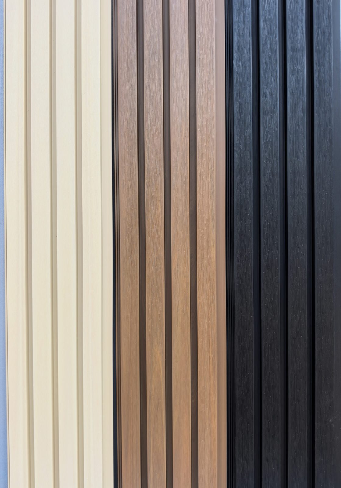 Maple, Teak, and Black WPC cladding boards close up, showing how the three tones sit together